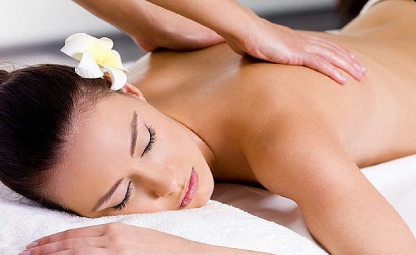 Beautiful woman having relaxing massage in spa salon